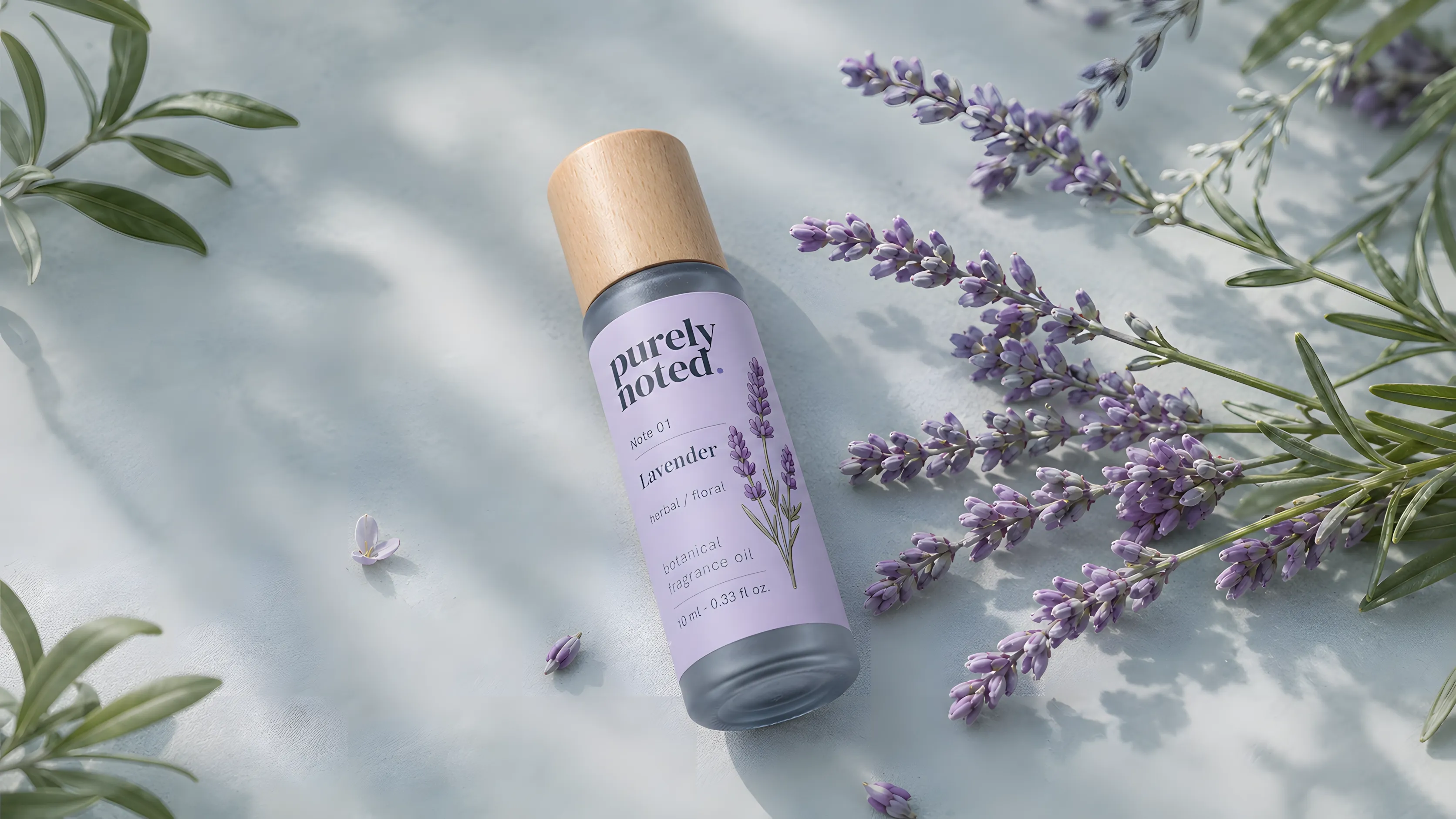 Purely Noted lavender botanical fragrance oil with fresh lavender sprigs.